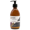 A sleek amber glass bottle of ancient wisdom body lotion with black pump in blackberry and almond seed oil scent