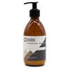 A sleek amber glass bottle with black pump body lotion scented with coconut lemon featuring seed oil