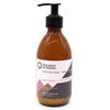 A sleek amber glass bottle of ancient wisdom body lotion with black pump, raspberry and pomegranate scent and seed oil
