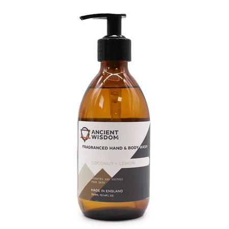 A sleek amber glass bottle of body wash with black pump in coconut and lemon scent for hand and body use