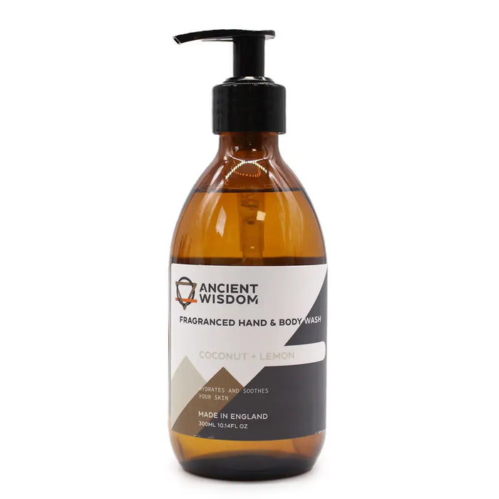 A sleek amber glass bottle of body wash with black pump in coconut and lemon scent for hand and body use