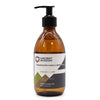 A sleek amber glass bottle of ancient wisdom body wash with black pump in mango and lime scent 300ml