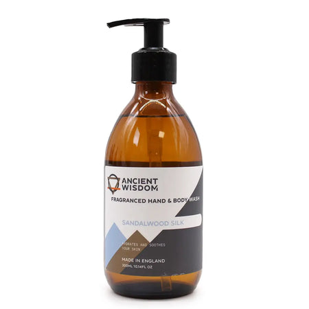 A sleek amber glass bottle with black pump labeled ancient wisdom sandalwood silk body wash 300ml