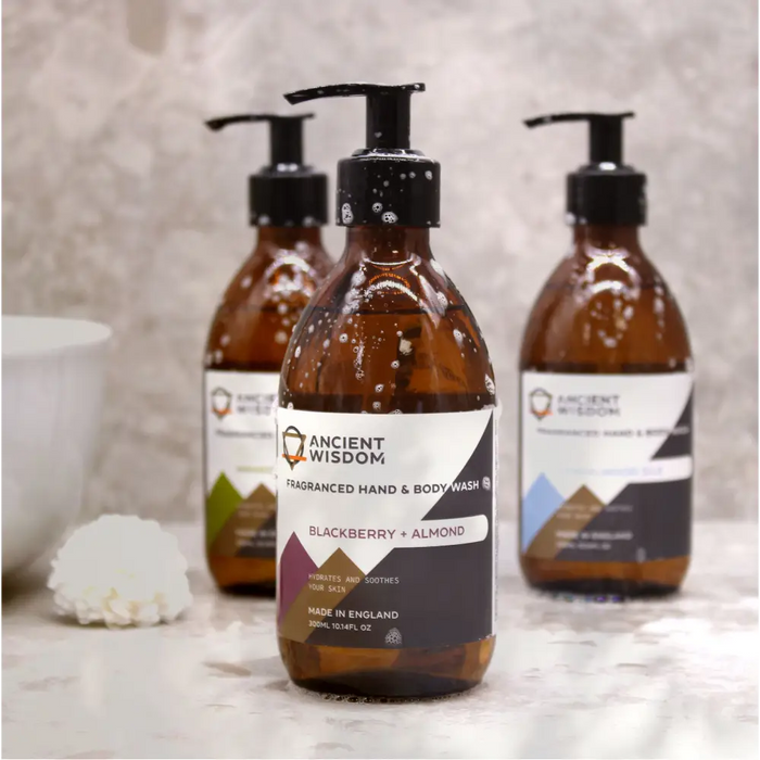 Amber glass bottle of ancient wisdom sandalwood silk body wash with black pump in blackberry and almond scent