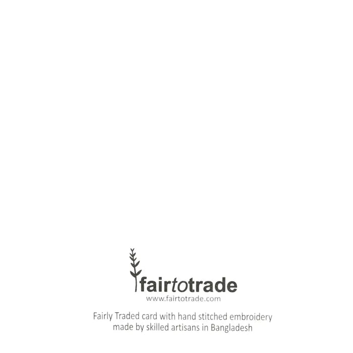 Fairtrade hand-embroidered christmas card with a green christmas tree design and visible stitching on fabric material
