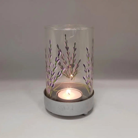 Clear glass tealight lantern with lavender design hand-painted in purple and green on a gray metal base