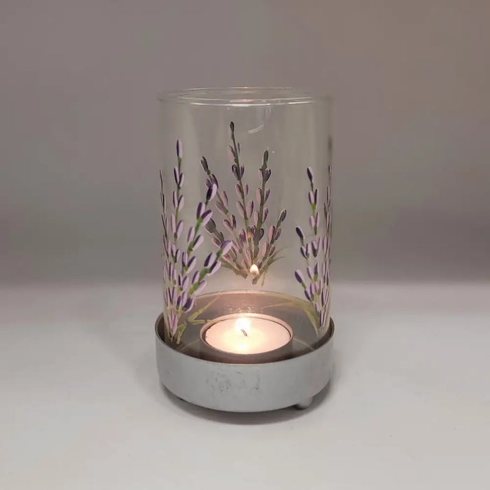 Clear glass tealight lantern with lavender design hand-painted in purple and green on a gray metal base