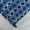 Handmade indigo runner featuring a deep indigo cotton textile with a bold white geometric heerak pattern and fringed edges