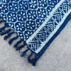 Handmade indigo runner made of cotton with white floral and geometric patterns and fringed edges from madjid tiles