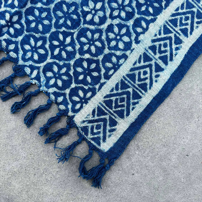 Handmade indigo runner made of cotton with white floral and geometric patterns and fringed edges from madjid tiles
