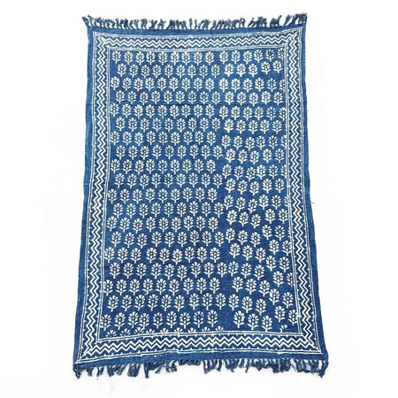 Handmade indigo throw with white leaf motifs and zigzag border in indigo blue, finished with fringed edges