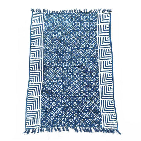 Handmade indigo throw with white geometric patterns and fringed edges made of blue cotton indigo throw rug