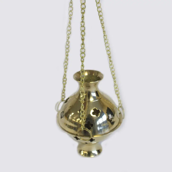 Gold-colored brass incense burner with clover cutouts and hanging chain for use with charcoal and resin