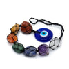 A vibrant hanging chakra stone pendant with seven colorful netted gemstones and a blue evil eye charm