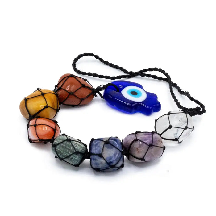 Hanging chakra stone pendant with seven colorful polished stones wrapped in black macrame and a blue evil eye charm