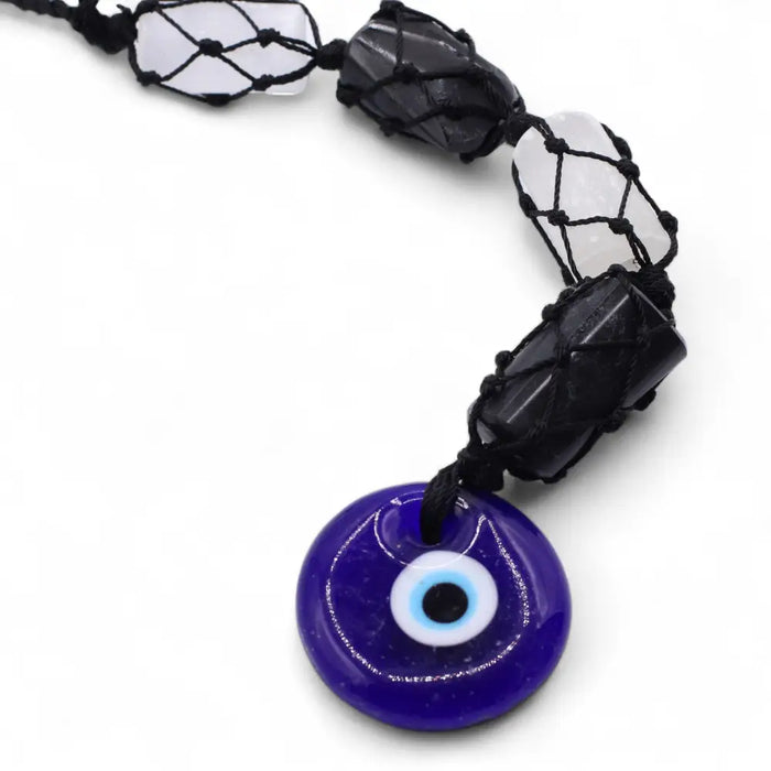 Hanging stone pendant with cobalt blue evil eye glass and black macrame cord with clear quartz and black tourmaline stones