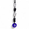 A vibrant blue glass evil eye pendant hanging from a black macrame cord with black tourmaline and selonite beads