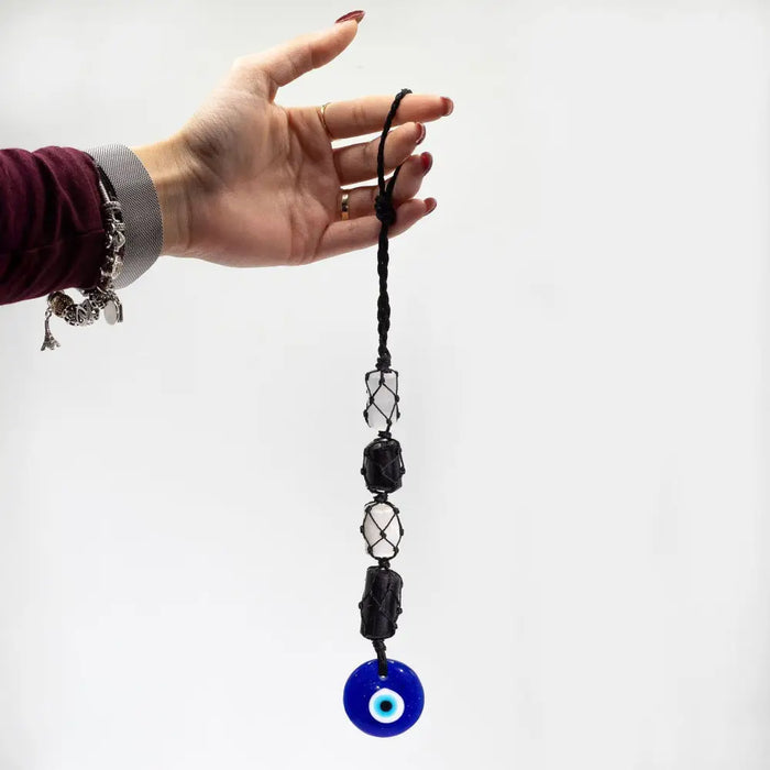 Black braided cord pendant with black and clear crystal beads and a blue glass evil eye charm