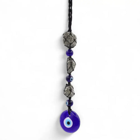 A cobalt blue glass evil eye pendant with pirite stones hangs from a black cord with silver gray and blue beads