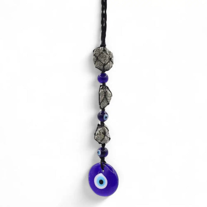 A cobalt blue glass evil eye pendant with pirite stones hangs from a black cord with silver gray and blue beads