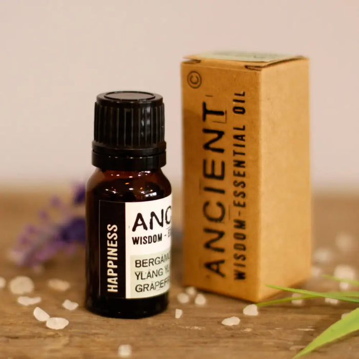 A small amber glass bottle with black cap and white label of happiness essential oil blend 10ml oil blend product