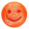 Happy scrub soap bar grapefruit is a vibrant orange circular scrub soap with a smiley face and fibrous texture