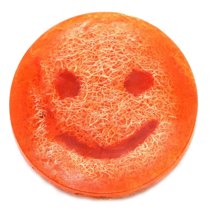 Happy scrub soap bar grapefruit is a vibrant orange circular scrub soap with a smiley face and fibrous texture