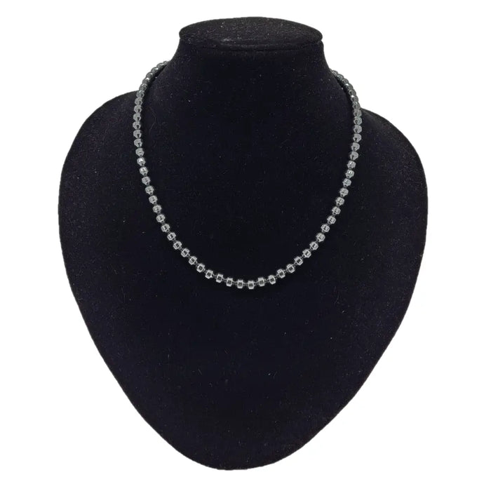 Silver beaded necklace with small faceted hematite barrel beads on a delicate uniform chain