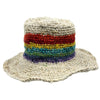 A handcrafted hemp and cotton festival hat with a wide brim and rainbow stripes on a natural woven crown