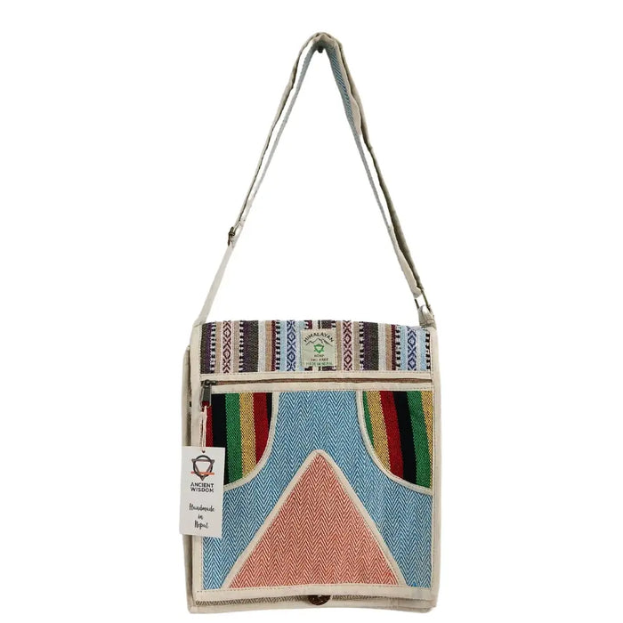 A colorful hemp laptop messenger bag with geometric blue red green yellow stripes and a coral triangle on herringbone background