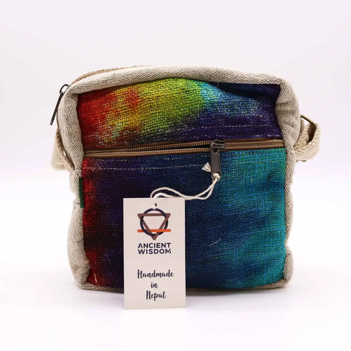A hemp messenger bag with a rainbow gradient handwoven natural fiber fabric and beige canvas trim crossbody style