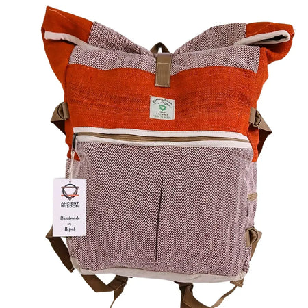 Hemp trekking rolling backpack in orange and pink herringbone with tan roll-top closure and brown straps