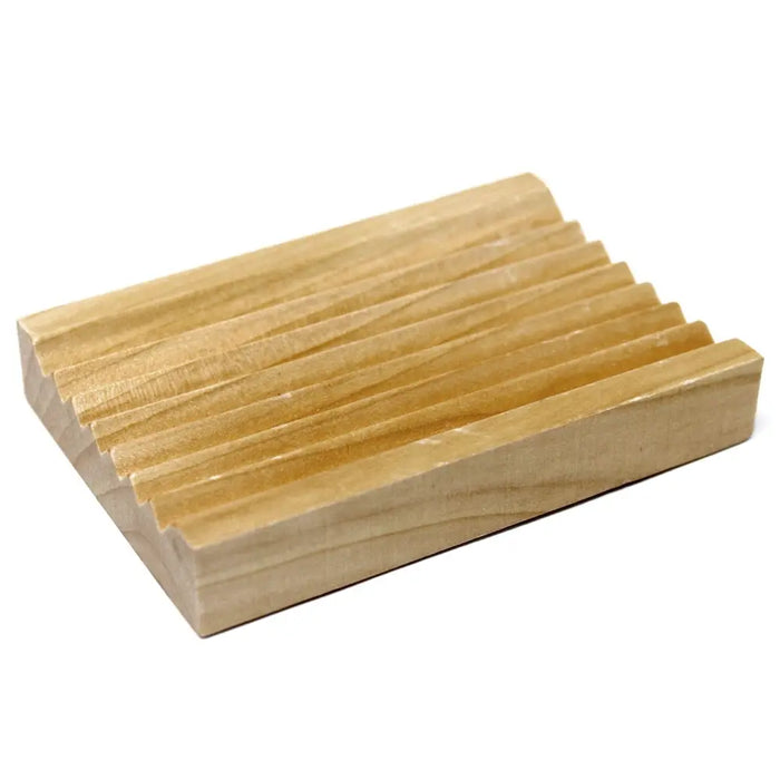 Light-colored hemu wood soap dish with parallel grooves designed for holding soap bars and draining water