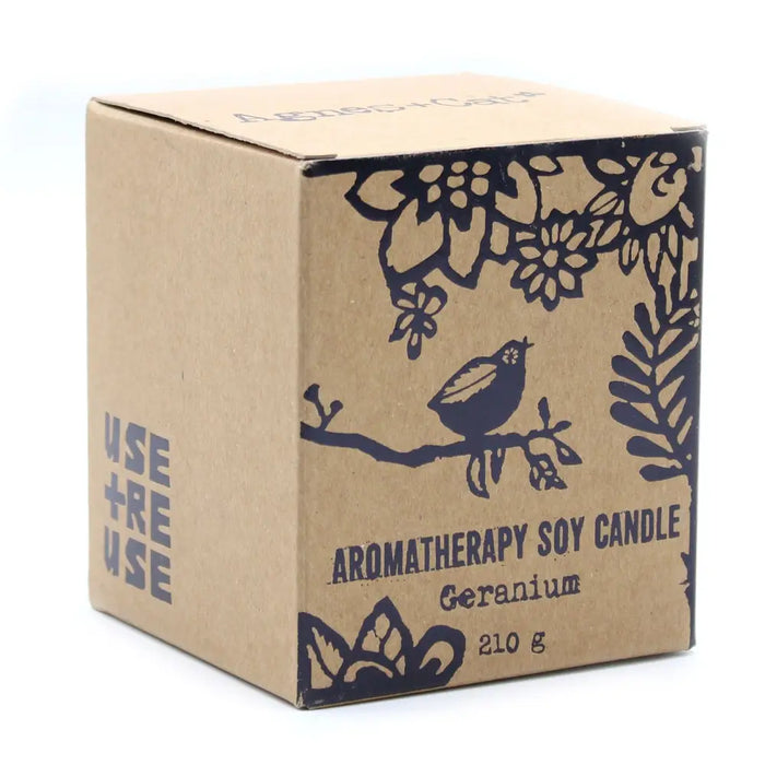 A brown cardboard herb garden candle with black floral and bird illustrations soy wax and wooden wick geranium scent