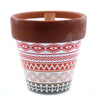 Terracotta pot candle with red white and black geometric patterns featuring soy wax mint herb garden scent