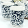 Blue and white ceramic mugs with intricate leafy vine patterns part of a herbal teapot set with blue pattern design