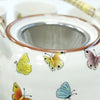White ceramic teapot with colorful butterfly decals brown rim and stainless steel strainer in herbal teapot set butterflies