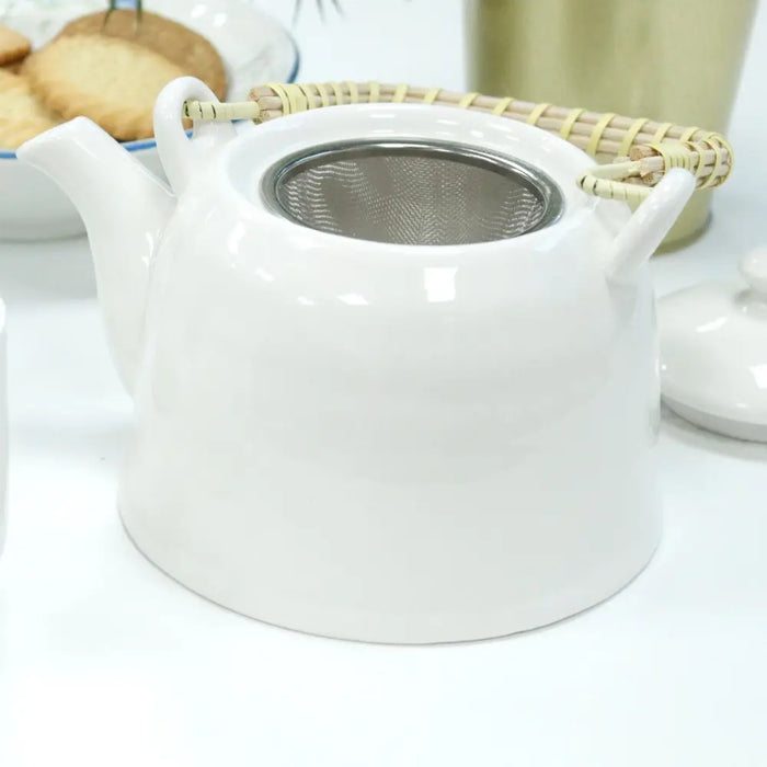 White ceramic herbal teapot with stainless steel infuser and woven bamboo handles for loose leaf tea brewing