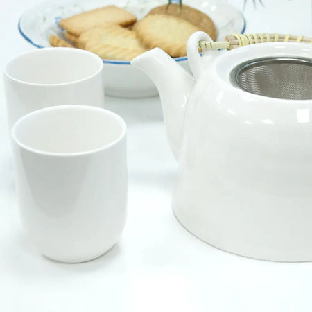 White ceramic teapot with stainless steel infuser and bamboo handle from the herbal teapot set classic white