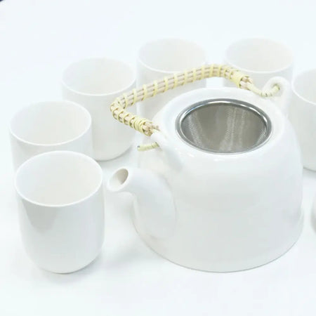White ceramic teapot with woven bamboo handle and stainless steel infuser for herbal tea brewing