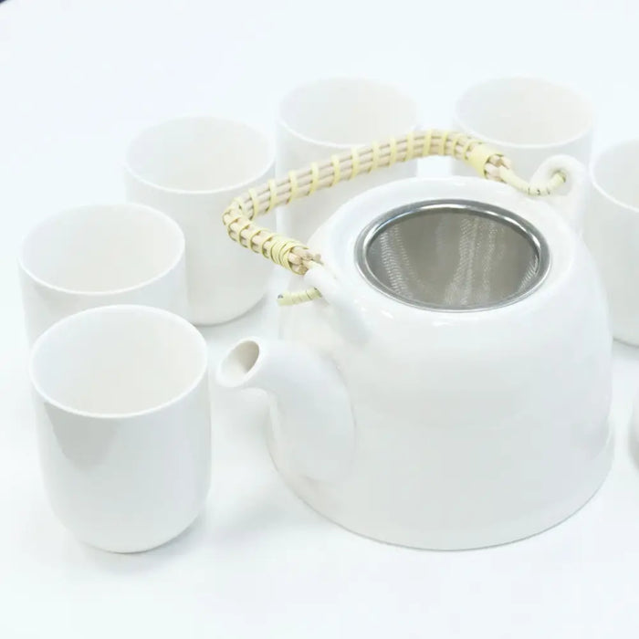 White ceramic teapot with woven bamboo handle and stainless steel infuser for herbal tea brewing