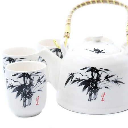 White ceramic herbal teapot with black bamboo painting red calligraphy and woven handle in an oriental style