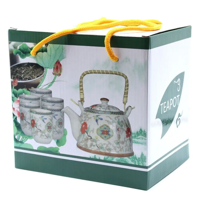 A white stone porcelain teapot with bamboo handle and red green gold floral patterns in an oriental style