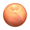 A smooth round orange candle with a central wick hole in a himalayan salt tealight holder round design