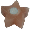 A peach-colored himalayan salt star-shaped tealight holder with a smooth surface and circular indentation for candle