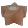 Peach-colored star-shaped himalayan salt tealight holder with natural stone texture and white candle in center