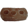A rustic rectangular himalayan salt candle holder with three circular tealight holders in a soft pink hue