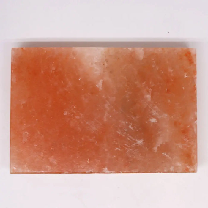 A rectangular pink himalayan salt cooking plate with natural texture and smooth surface for salt cooking