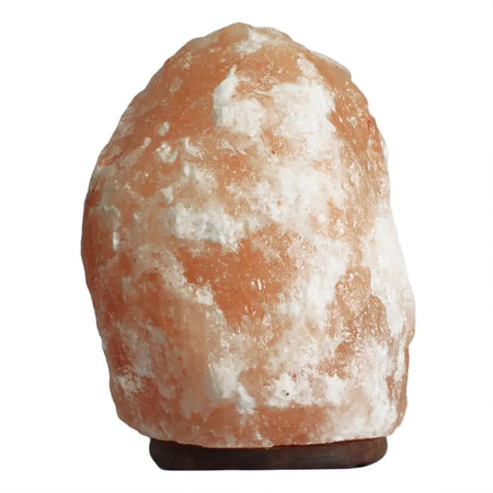 A himalayan salt lamp 20-25kg with a rough orange and white crystalline surface showing hygroscopic properties in humid conditions