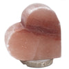 A smooth pinkish-red himalayan salt lamp heart with natural mineral texture highlighting its hygroscopic properties